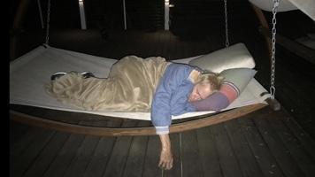 John Tesh resting in a hammock during cancer treatment