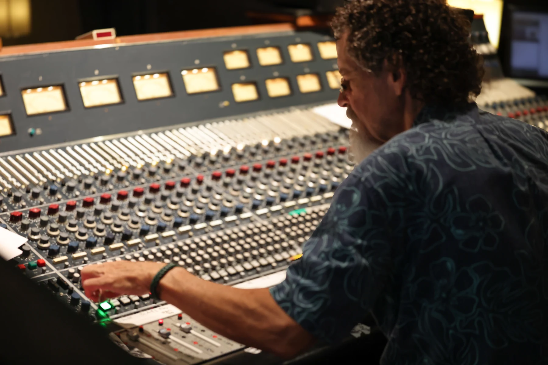 An engineer working at the studio mixing console